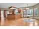 Open kitchen with hardwood floors, a large island, and bright natural light at 1972 Gold Camp Way, Franktown, CO 80116