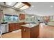 Spacious kitchen with granite counters, wood cabinets, island, stainless appliances and hardwood flooring at 1972 Gold Camp Way, Franktown, CO 80116