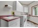 Laundry room featuring a sink, counter space, cabinets and a washer and dryer at 1972 Gold Camp Way, Franktown, CO 80116