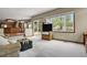 Bright living room with large windows and access to an outdoor deck at 1972 Gold Camp Way, Franktown, CO 80116