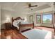 Main bedroom features a tray ceiling, wood floors and large windows with scenic views at 1972 Gold Camp Way, Franktown, CO 80116