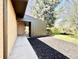 A brick home with mulched flowerbeds and side covered porch at 5563 E Jefferson Ave, Denver, CO 80237