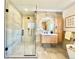 Modern bathroom with glass shower, wood vanity, tile floors and walls at 5563 E Jefferson Ave, Denver, CO 80237