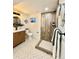 Bathroom with wood-look tile shower and patterned tile floor at 5563 E Jefferson Ave, Denver, CO 80237