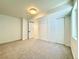 This bedroom features neutral carpet, a ceiling light, and a double door closet at 5563 E Jefferson Ave, Denver, CO 80237