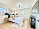 Bright bedroom with a modern light fixture, stylish decor, and light wood flooring at 5563 E Jefferson Ave, Denver, CO 80237