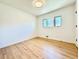 Bright bedroom with hardwood floors and natural light from multiple windows at 5563 E Jefferson Ave, Denver, CO 80237
