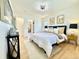 Bright bedroom features a comfortable bed, stylish decor, and a convenient walk-in closet at 5563 E Jefferson Ave, Denver, CO 80237