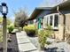Inviting front entrance with a stylish turquoise door and modern landscaping features at 5563 E Jefferson Ave, Denver, CO 80237