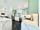Modern kitchen with sage cabinets, stainless appliances, black marble floors, and white countertops for an inviting space at 5563 E Jefferson Ave, Denver, CO 80237