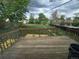 A wooden deck overlooking a lush backyard with plenty of green grass and trees in a suburban neighborhood at 1717 Oswego St, Aurora, CO 80010