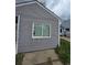 Gray siding on a home with green grass and minimal landscaping in the yard at 1717 Oswego St, Aurora, CO 80010