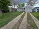 Charming single-story home with grey siding, a driveway, and a partially landscaped front yard at 1717 Oswego St, Aurora, CO 80010