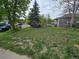 A home with a lush green front yard and mature trees in a quiet residential neighborhood at 1717 Oswego St, Aurora, CO 80010