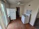 Bright kitchen with a white refrigerator and stove plus access to the backyard via sliding glass doors at 1717 Oswego St, Aurora, CO 80010
