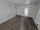 Simple living room space with neutral carpet and access to multiple rooms at 1717 Oswego St, Aurora, CO 80010