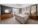 Spacious bedroom with a large bed, dresser, and stylish decor at 2823 Jasmine St, Denver, CO 80207