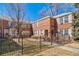 Charming brick apartment building with a gated front lawn at 2823 Jasmine St, Denver, CO 80207