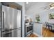 Open kitchen with stainless steel appliances and view into dining area at 2823 Jasmine St, Denver, CO 80207
