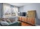 Living room featuring hardwood floors, a wooden cabinet, and a large window at 2823 Jasmine St, Denver, CO 80207