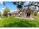 Expansive backyard featuring a well-manicured lawn, a concrete patio, and mature trees for shade and privacy at 8216 S Tempe Ct, Aurora, CO 80016