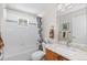 Bright bathroom with a tub and shower combo, granite countertops, and tile flooring at 8216 S Tempe Ct, Aurora, CO 80016