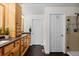 Bathroom featuring a wooden double vanity, dark floors, and a tiled shower at 8216 S Tempe Ct, Aurora, CO 80016