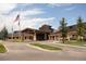 Beautiful clubhouse featuring stone and timber construction, landscaped entrance, and covered entrance at 8216 S Tempe Ct, Aurora, CO 80016