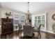 Inviting dining room featuring wood floors, a chandelier, and abundant natural light from the windows at 8216 S Tempe Ct, Aurora, CO 80016