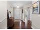 Welcoming entryway featuring dark wood floors, neutral paint, and an elegant mirror at 8216 S Tempe Ct, Aurora, CO 80016