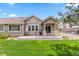 Charming home with a well-maintained lawn, a grill, a concrete patio, and a beautifully landscaped yard at 8216 S Tempe Ct, Aurora, CO 80016