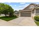 Beautiful home exterior showcasing a two-car garage, stone accents, and a manicured front lawn at 8216 S Tempe Ct, Aurora, CO 80016