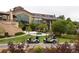 Golf carts parked outside an attractive clubhouse building surrounded by trees and lush landscaping at 8216 S Tempe Ct, Aurora, CO 80016