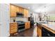 Well-appointed kitchen with stainless steel appliances, granite countertops, and wooden cabinetry at 8216 S Tempe Ct, Aurora, CO 80016