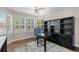 Cozy home office with a ceiling fan, built-in shelves, and ample natural light at 8216 S Tempe Ct, Aurora, CO 80016