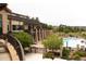 Exterior view of pool area with stone pillars, wrought iron fence, and a building with covered patios at 8216 S Tempe Ct, Aurora, CO 80016