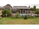 View of outdoor pool, patio furniture, and manicured lawns behind a decorative iron fence at 8216 S Tempe Ct, Aurora, CO 80016