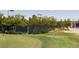 Well-manicured community tennis court and putting green surrounded by lush landscaping at 8216 S Tempe Ct, Aurora, CO 80016