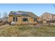 Expansive backyard featuring a well-maintained lawn, mature trees and a small deck at 884 W 124Th Dr, Denver, CO 80234
