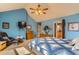 A calming bedroom features high ceilings, a ceiling fan, neutral carpet, and a comfortable chair with an ottoman at 884 W 124Th Dr, Denver, CO 80234