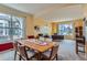 Cozy dining room with a window, table with seating for six, and carpeted floor, creating a warm and inviting space at 884 W 124Th Dr, Denver, CO 80234