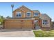 Charming two-story home with a well-manicured lawn and a three-car garage at 884 W 124Th Dr, Denver, CO 80234