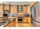 Modern kitchen featuring wood cabinets, stainless steel appliances, and granite countertops at 884 W 124Th Dr, Denver, CO 80234