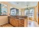 A bright kitchen with granite countertops, wood floors, and stainless steel sink at 884 W 124Th Dr, Denver, CO 80234