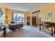 Inviting living room area with large window, carpeted floor, and wooden desk and chair, creating a welcoming atmosphere at 884 W 124Th Dr, Denver, CO 80234
