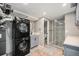 The remodeled basement includes a laundry area with a stacked washer and dryer and a contemporary bathroom at 1244 S Wright St, Lakewood, CO 80228