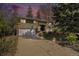 Charming two-story home with mature trees, a paved driveway, and an attached two-car garage at 1244 S Wright St, Lakewood, CO 80228
