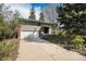 A well maintained two-story home featuring a two car garage, brick accents, and a long driveway at 1244 S Wright St, Lakewood, CO 80228