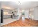 Stylish open kitchen with stainless appliances, gray cabinets, and hardwood floors in the adjacent living area at 1244 S Wright St, Lakewood, CO 80228