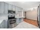 Renovated kitchen featuring stainless steel appliances, sleek countertops, and modern lighting at 1244 S Wright St, Lakewood, CO 80228